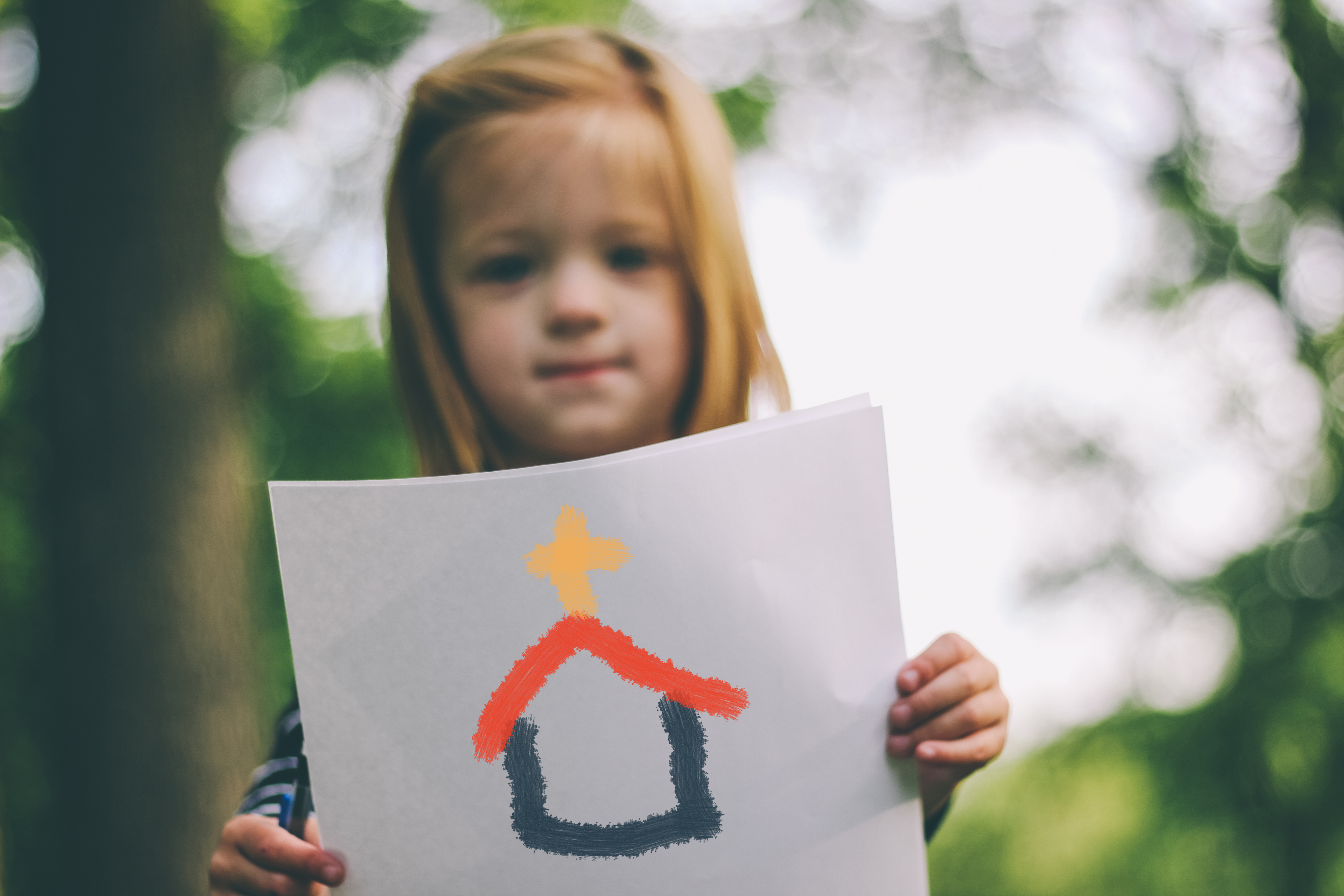 Girl holding drawing of Church